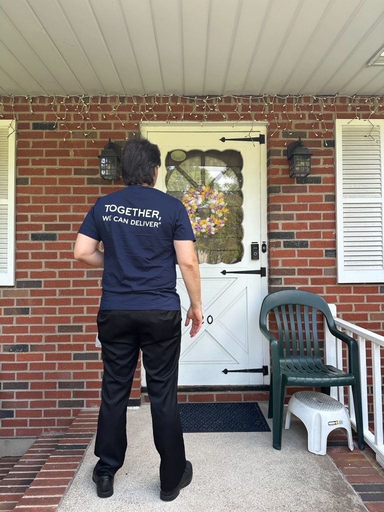 A volunteer delivering a meal to one of the clients of Meals on Wheels. The volunteer app includes a route map, dietary needs for each client, and a location for adding notes.